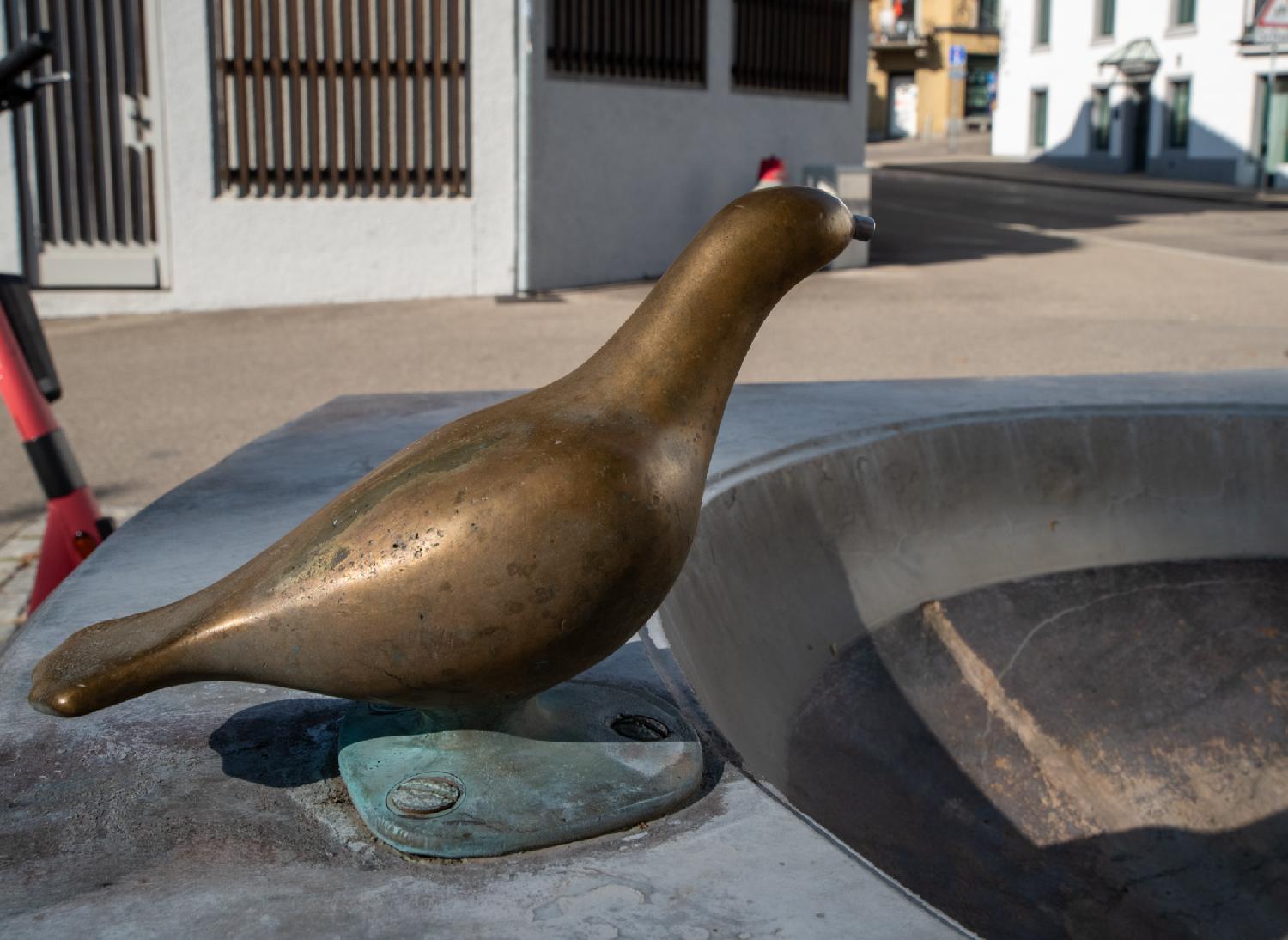 Drinking fountain on Altenhofstrasse in Zürich: detail of a drinking fountain (currently off) made of a metallic stylized bird.