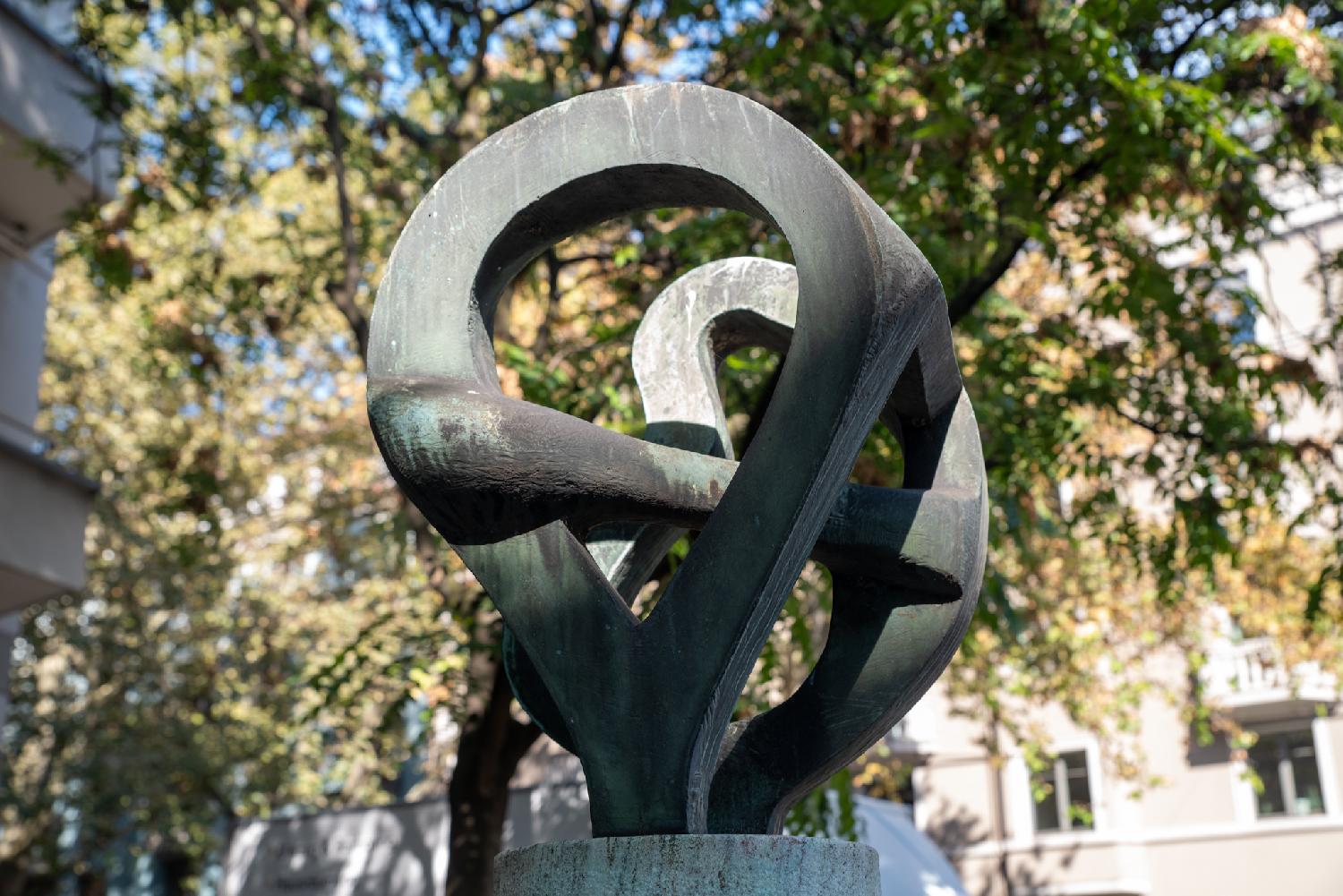 Abstract bronze sculpture; intertwined bronze loops.