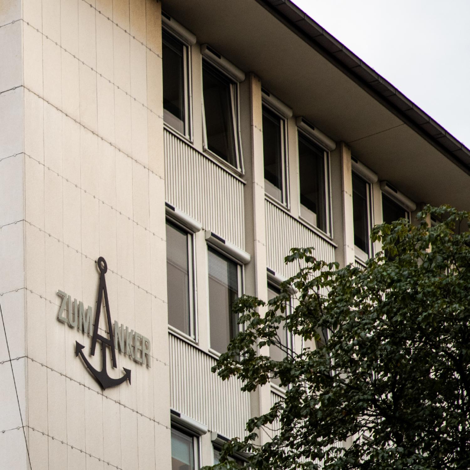 A Zum Anker sign on a building; the A is an anchor.